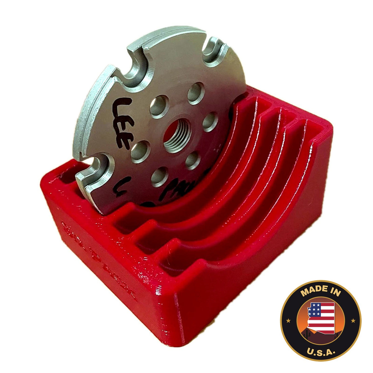 Red benchtop rack holding a LEE Six Pack Pro shell plate, Made in USA badge