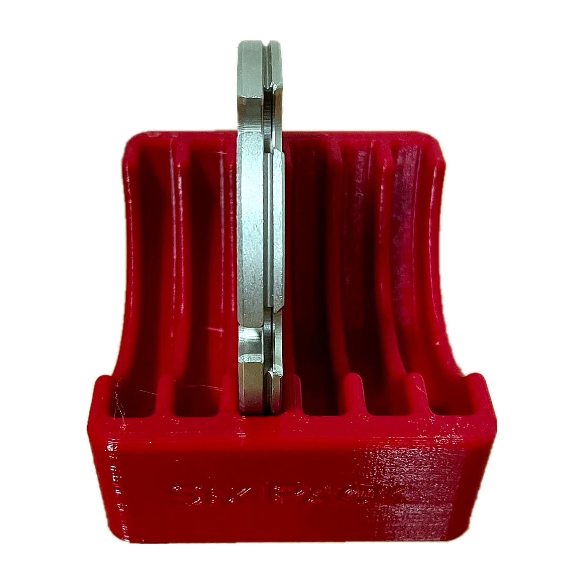 Red benchtop rack with a shell plate standing in a slot, front view