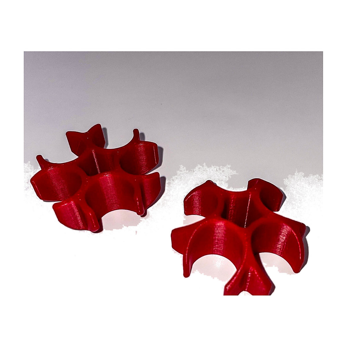 Two red 5-tube case feed support clamps