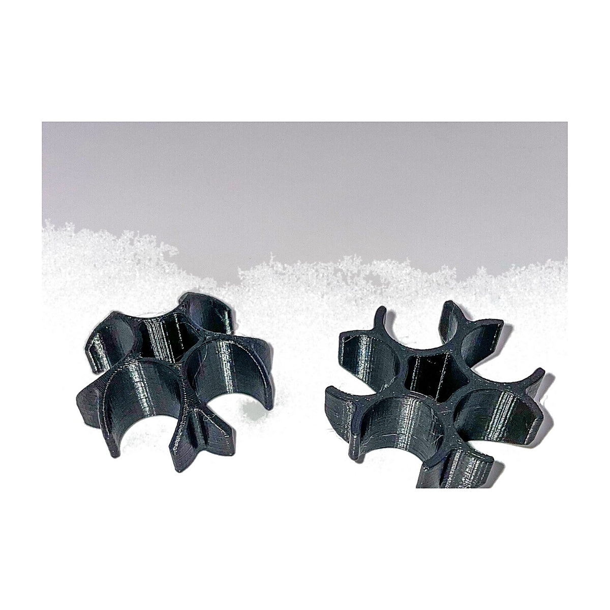 Two black 5-tube case feed support clamps