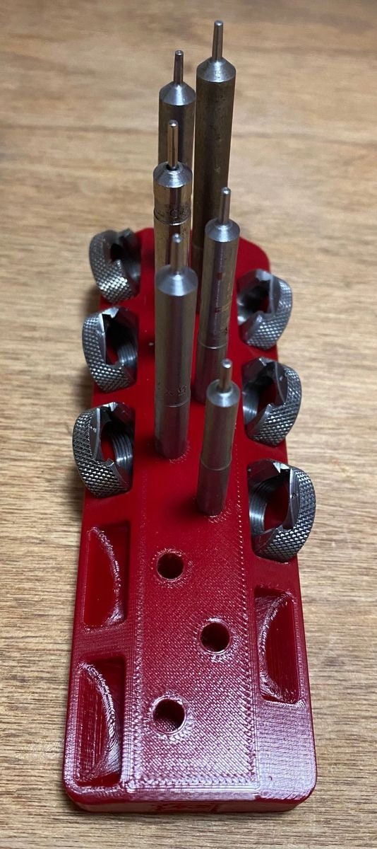 Red rack with LEE case length gauges and shell holders, top view