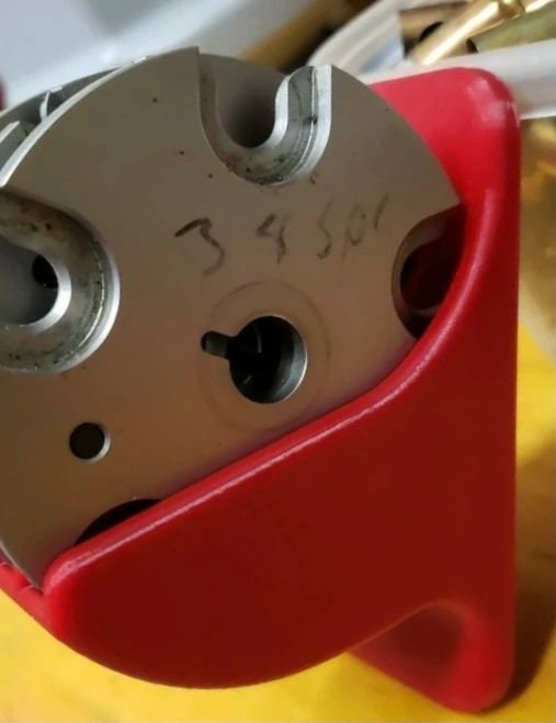 Hornady LNL shell plate seated in the red wall rack, close-up
