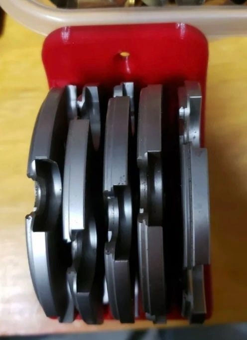 Red wall rack holding 5 Hornady Lock-N-Load shell plates, front view